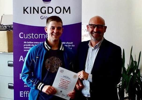Michael Murrison receiving his certificate from Kingdom Group chief executive Bill Banks
