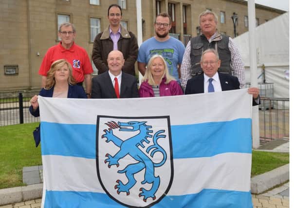 Members of the Kirkcaldy Ingolstadt Association and councillors with the Ingolstadt flag in Kirkcaldy town square