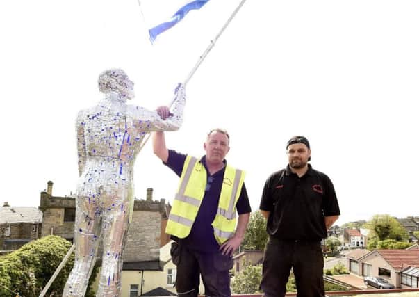 Andrew Davies with his flag-bearer sculpture - with employee Chris Brown.  Pic credit: Fife Photo Agency.