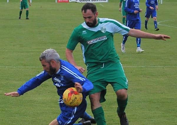 Kevin McNaughton of Kirriemuir Thistle and Andy Adam of Thornton Hibs tussle for the ball