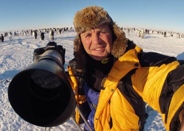 Doug Allan filming at an Emperor Penguin Colony in the Antarctic.