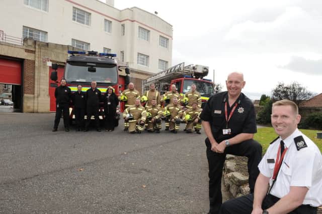 Stephen Thomson and Roddie Keith with firefighters outside the station.  Picture: George McLuskie