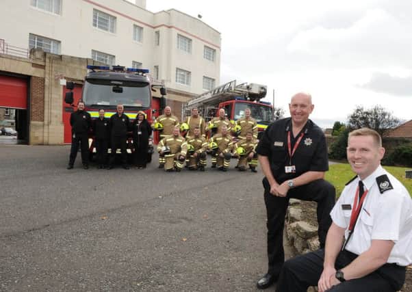Stephen Thomson and Roddie Keith with firefighters outside the station.  Picture: George McLuskie