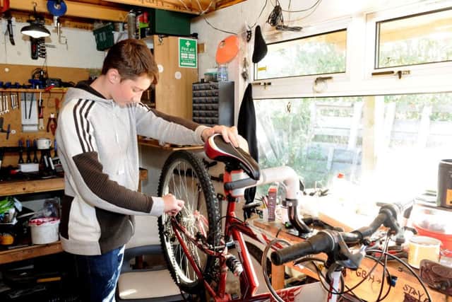 Brandon Duff carries out repairs on a bike