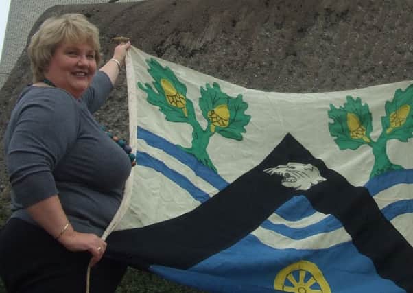 Linda Ballingall, chairman of Glenrothes Heritage Centre, pictured with the GDC flag, one of the artefacts stolen.
