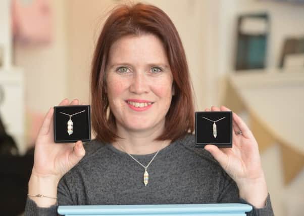 Louise Humpington with her pendants which commemorate angel babies. Pic: George Mcluskie.