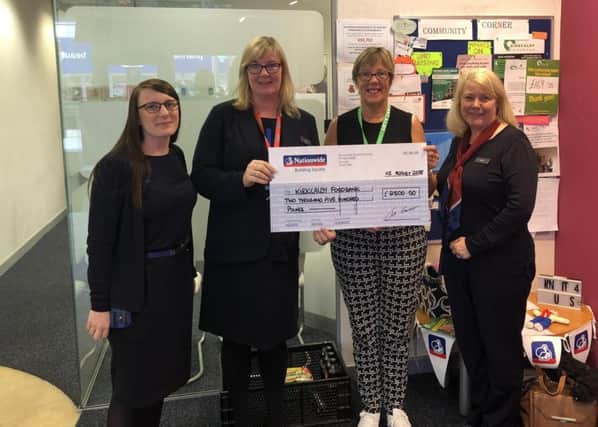 Lyn Elder hands over the cheque to Joyce Leggate along with Shona Gardner and Sarah Rowlands from her team at the Kirkcaldy Branch.