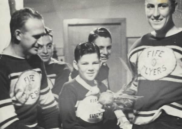 Bert Smith, mascot, with the original 1938 Fife Flyers team, in the dressing room