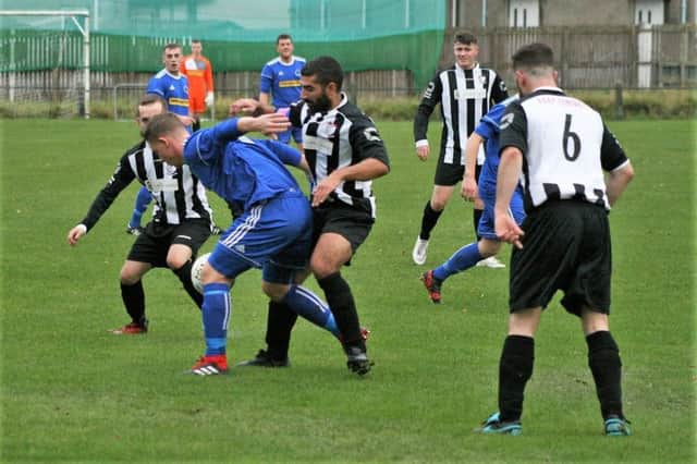 The Newburgh midfield battle to win the ball back. Pic by Graham Strachan.