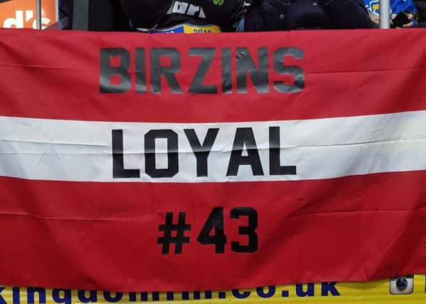Fife Flyers fans display a Latvian flag with the 'Birzins Loyal' slogan.