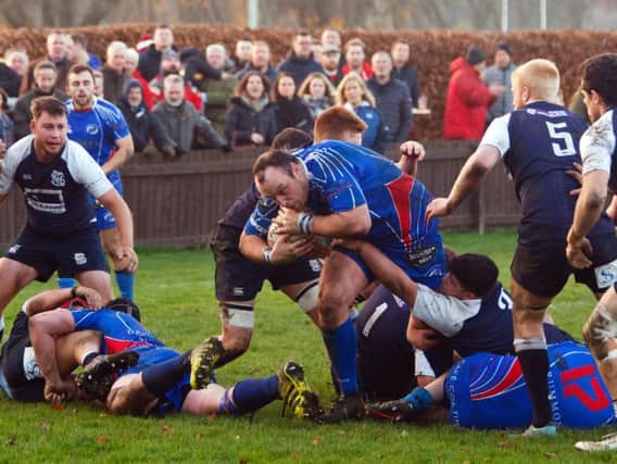 Kirkcaldy tight head Michael Harper bulldozes past Selkirk tacklers. Pic: Michael Booth
