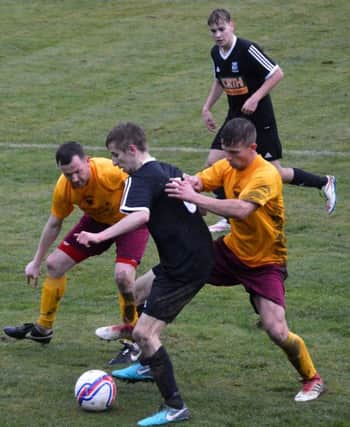 Kennoway goalscorer Dylan Muir is crowded out against Whitburn.