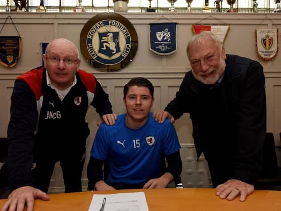 Kevin Nisbet signs a new contract with Raith Rovers, flanked by manager John McGlynn and chairman Bill Clark. Pic: Fife Photo Agency