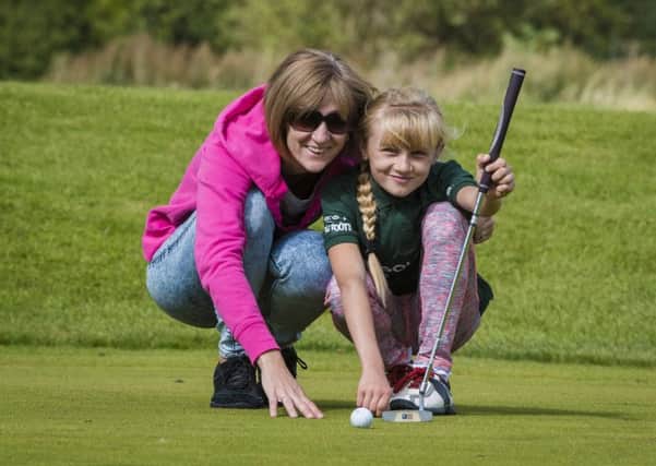 A Mother and daughter enjoy a GolfSixes event run by the Golf Foundation.
