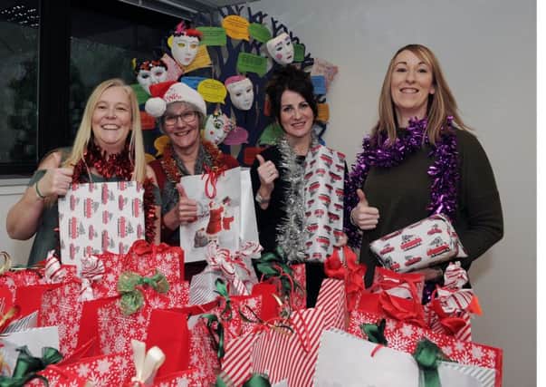 The team at Fife Women's Aid holding Christmas presents and wearing tinsel to launch their annual Christmas appeal for money and unwrapped presents. From left: Keri Duffi, Margaret Fagan, Alison Sexton, Pauline Horsburgh. Pic: George McLuskie.