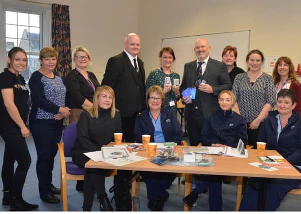 Kirkcaldy Masons lodge members making presentation of ipods for the dementia care department, Andrew Wishart with Helen Skinner and Finlay Ross.