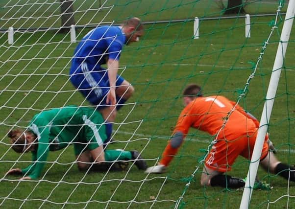 Thornton Hibs v Bathjgate Thistle Garry Thomson with the ball between his feet. David Taylor and goalie, Michael McGhee, were able to clear.