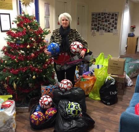 Jeanette from Platinum Hairdressing with donations for the appeal