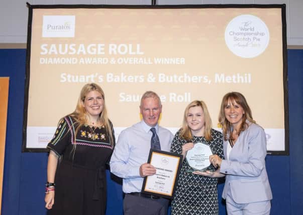 Stuart's receive the sausage roll award from Carol Smillie.