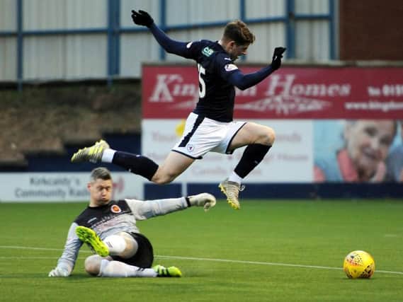 The moment Raith Rovers striker Kevin Nisbet picked up a hamstring injury, while attempting to take the ball around Stenhousemuir goalkeeper Graeme Smith. Pic: Fife Photo Agency