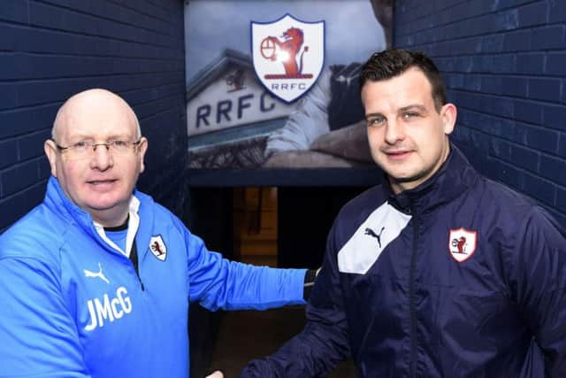 Raith manager John McGlynn congratulates club captain Kyle Benedictus on his new one-year contract extension. Pic: Fife Photo Agency