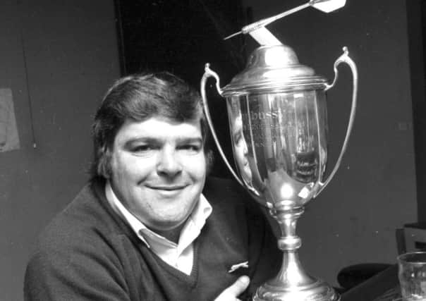 Jocky Wilson with his world trophy in 1982