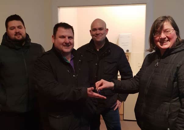 Scottish Paranormal members Ally, Greg and Ryan picking up the keys to the new centre.