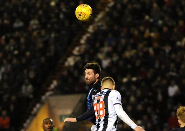 Chris Duggan towers above Dunfermline right-back James Craigen to win this header. Pics: Fife Photo Agency