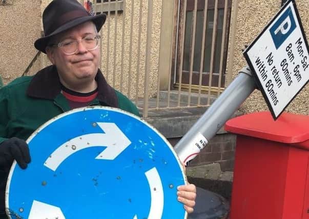 Cllr Johnny Tepping with the damaged sign in Newport