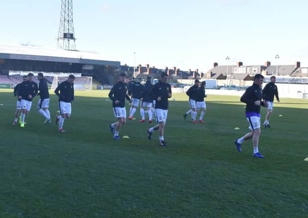 The East Fife players go through their warm up knowing the game won't kick off. Pic Kenny Mackay.