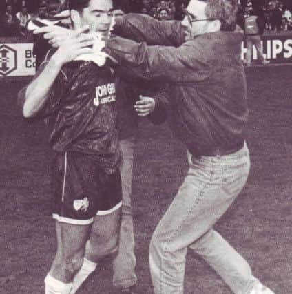 Hetherston embraced by a fan after Raith won the First Division title in 1993.
