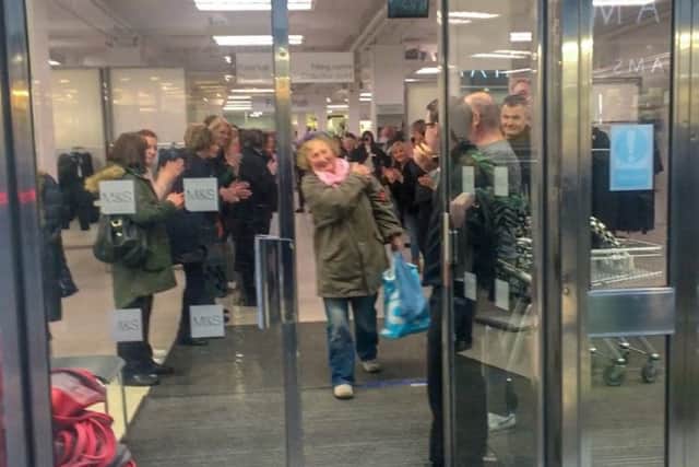 Staff cheer on their final customers.