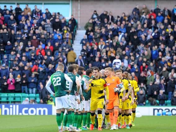 The 1700 Raith fans provide the backdrop as the teams line-up for the pre-match hand shakes. Pic: Fife Photo Agency