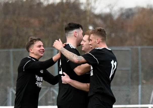YM players celebrate after finding the net against West Calder