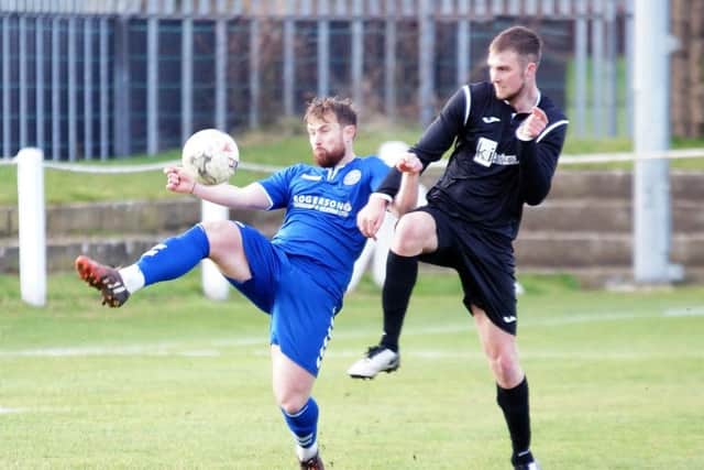 Dundonald (in blue) in action against Dalkeith