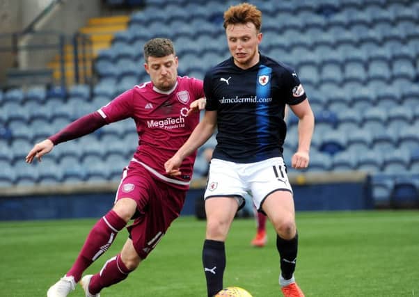 Dingwall vies for the ball with an Arbroath player
