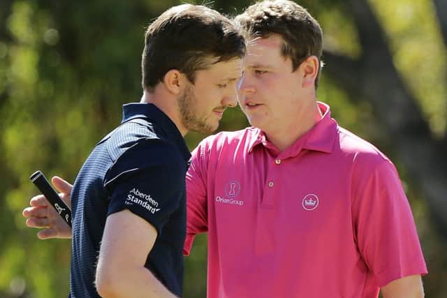 Connor Syme embraces fellow Scot Bob MacIntyre after knocking him out of the World Super 6. Pic by Getty.