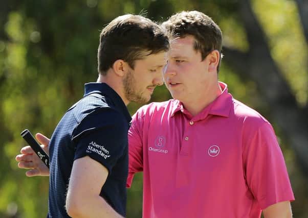 Connor Syme embraces fellow Scot Bob MacIntyre after knocking him out of the World Super 6. Pic by Getty.