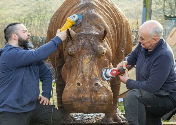 The final touches are made to a life size metal  hippopotamus by Rory and Kyran Thomas. Picture: SWNS