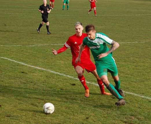 Lewis Payne and Iain Millar battle for possession.