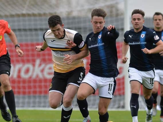 Ross Perry challenges Nathan Flanagan during Raith's 5-1 win in Dumbarton in September. Pic: Dave Johnston / Alba Pictures