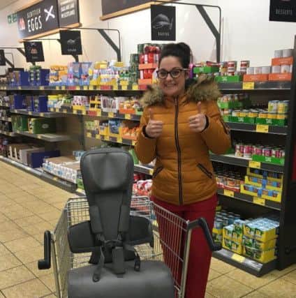 Charlene Londra with the specially-adapted trolley and seat for youngsters with special needs in Aldi, Ferrard Road, Kirkcaldy.