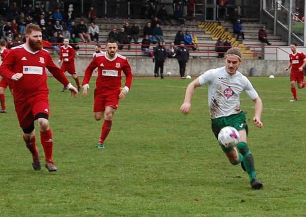 Thornton Hibs striker Garry Thomson takes on Glenrothes defender Gary Pearson in a 5-0 win for the Hibs