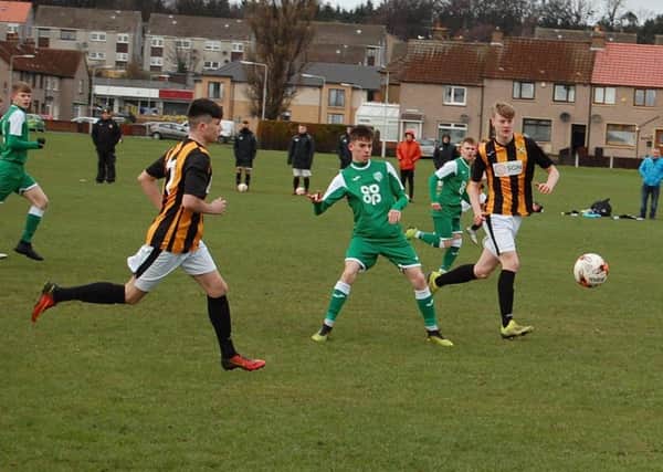 Archie Watson making the pass watched by East Fife's Jordan Lamont and Jack Matheson.