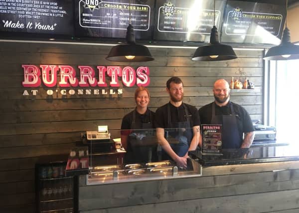 Ashley Walton, Dale Penman, and Steven Kelter prepare the burritos.