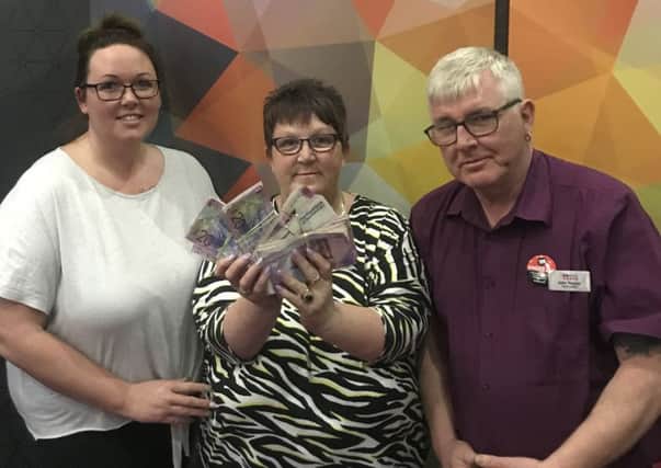 Bingo player Connie Johnston (centre) who called house in £35,000 prize night, winning £15,000 for herself, and £20,000 for the regulars at Club 3000 Kirkcaldy. Also pictured, daughter Kirsten and John Traynor of Club 3000