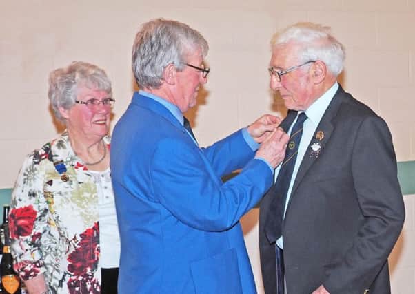 Scottish Curling President Graham Lindsay presenting 50 year medals to Mary Campbell and David Wilson.