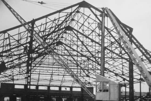 The walls are up, and the roof is beginning to form.