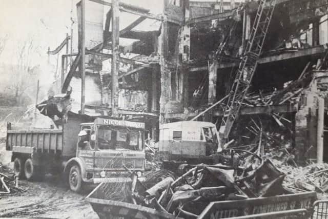 Demolition crews start to clear the remains of the fire.
