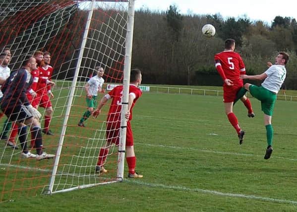 Thornton Hibs player Stuart Drummond heads the first goal against Glenrothes Juniors